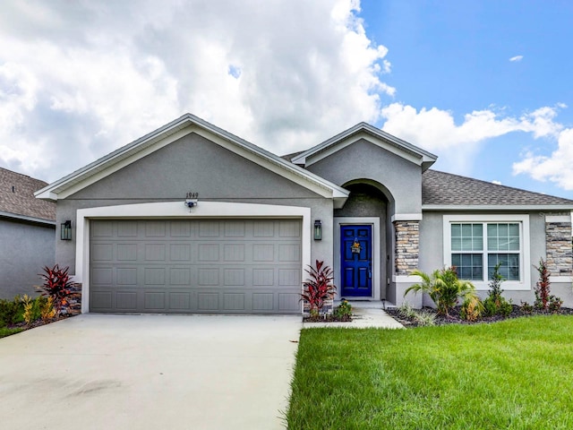 ranch-style house featuring a garage and a front lawn