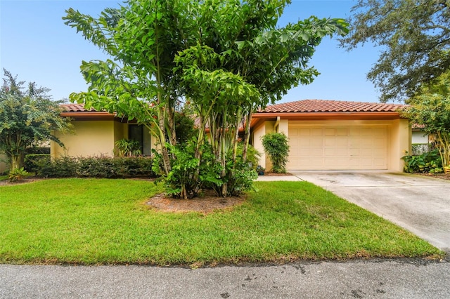 view of front of property with a tiled roof, a garage, and stucco siding