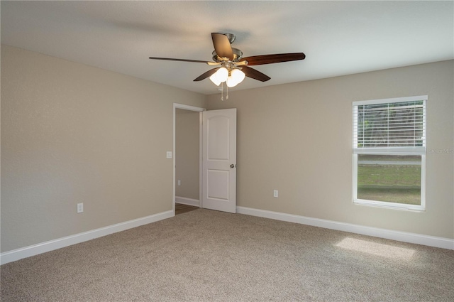 spare room featuring ceiling fan and carpet flooring