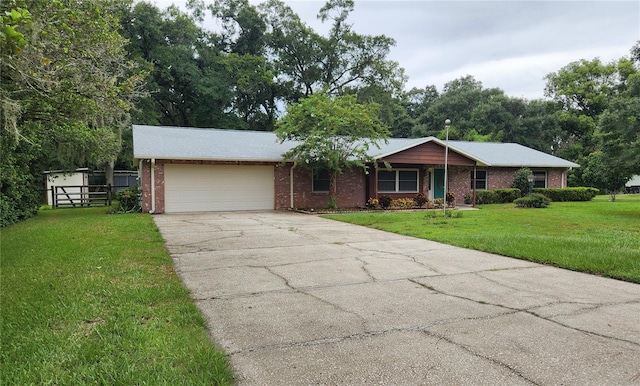 ranch-style house featuring a garage and a front lawn