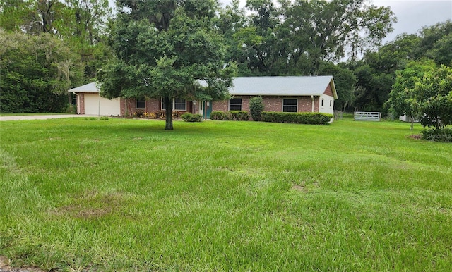 view of front of house featuring a garage and a front lawn