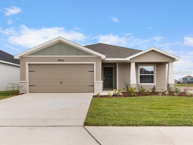 view of front facade with a garage and a front lawn