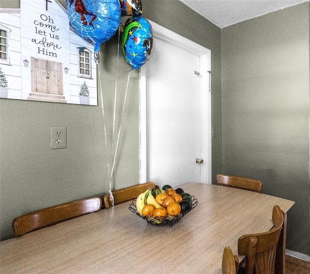 dining room with a textured ceiling and hardwood / wood-style flooring