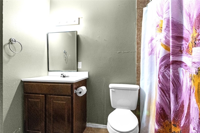 bathroom featuring vanity, toilet, and curtained shower