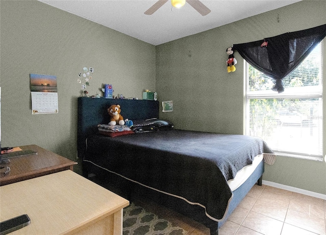 bedroom with ceiling fan and light tile patterned floors