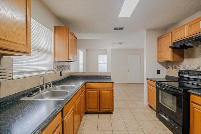 kitchen with black range with electric stovetop, kitchen peninsula, sink, and light tile patterned flooring