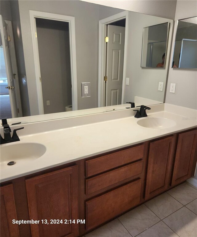 bathroom featuring vanity, toilet, and tile patterned flooring