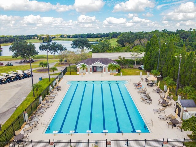 view of swimming pool with a water view and a patio