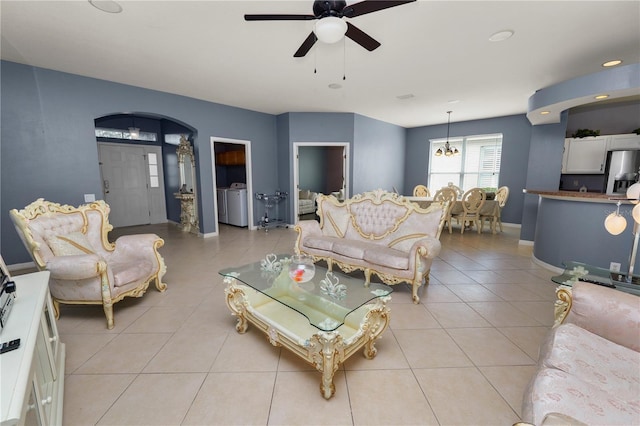 tiled living room featuring washing machine and dryer and ceiling fan