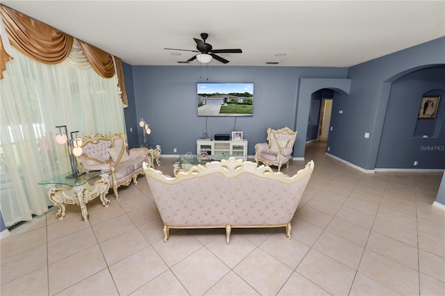 tiled living room with ceiling fan