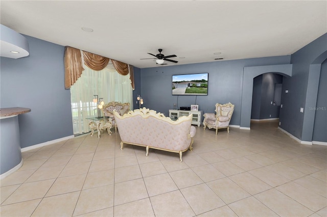 living room with ceiling fan and light tile patterned floors