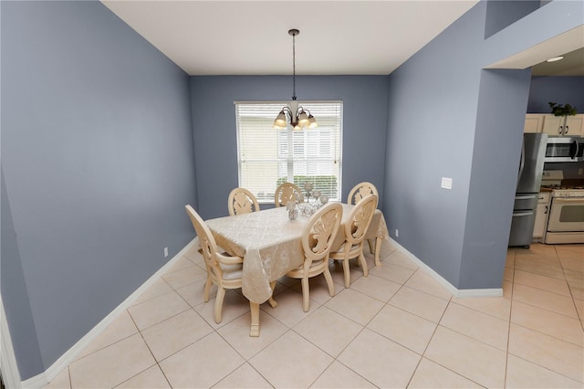 dining area with light tile patterned floors and an inviting chandelier