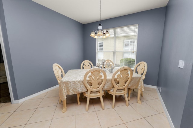 tiled dining space featuring a chandelier