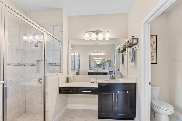 bathroom featuring toilet, a stall shower, baseboards, and vanity