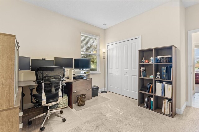 office area with light carpet and baseboards