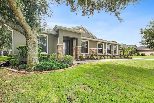 view of front of home featuring stone siding, a front lawn, and stucco siding