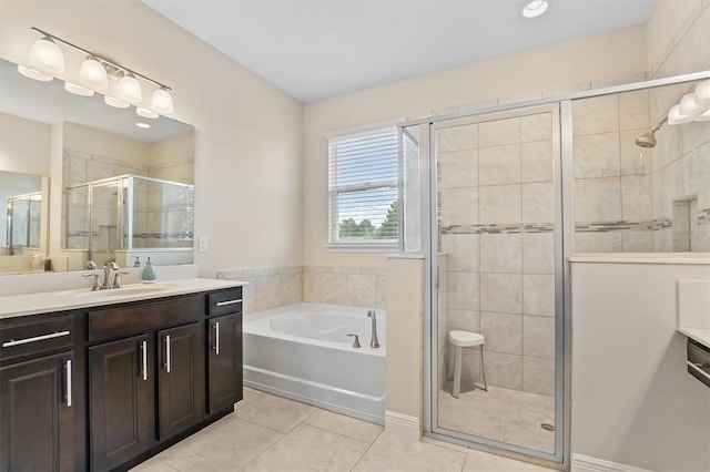 bathroom featuring a stall shower, vanity, a bath, and tile patterned floors