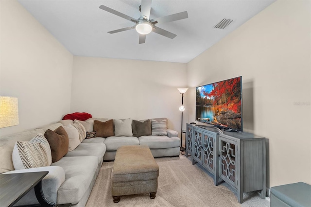 living area featuring a ceiling fan, light colored carpet, and visible vents