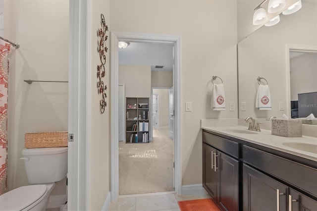 full bath with tile patterned flooring, toilet, a sink, baseboards, and double vanity