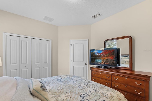 bedroom with visible vents and a closet