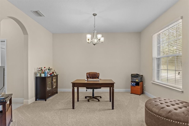 office space with baseboards, visible vents, arched walkways, light colored carpet, and an inviting chandelier