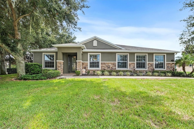 view of front of house featuring stone siding, a front lawn, and stucco siding