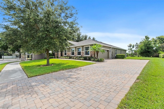 view of front of home featuring decorative driveway, an attached garage, a front yard, fence, and stone siding