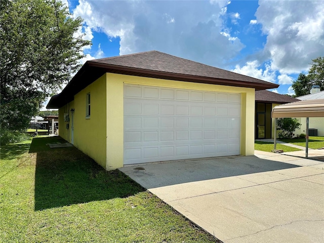 view of side of property with a yard and a garage