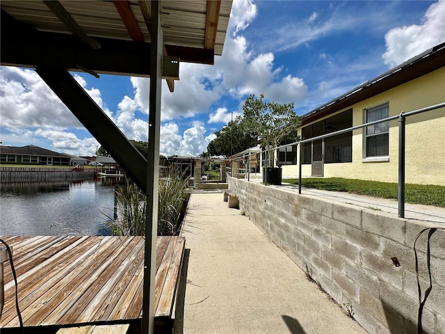 view of dock featuring a residential view and a water view