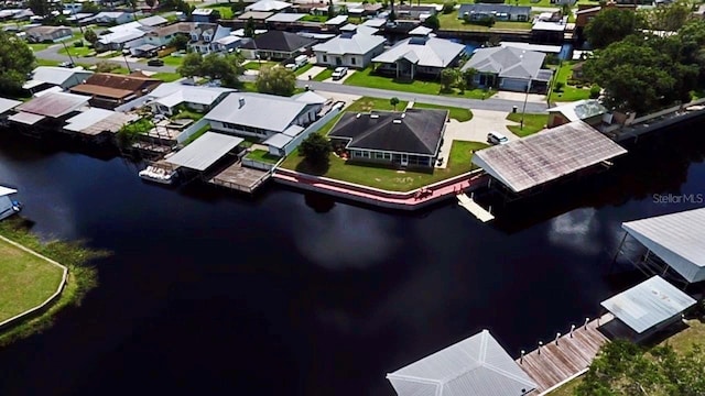 drone / aerial view featuring a residential view and a water view