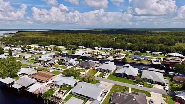 bird's eye view with a residential view, a view of trees, and a water view