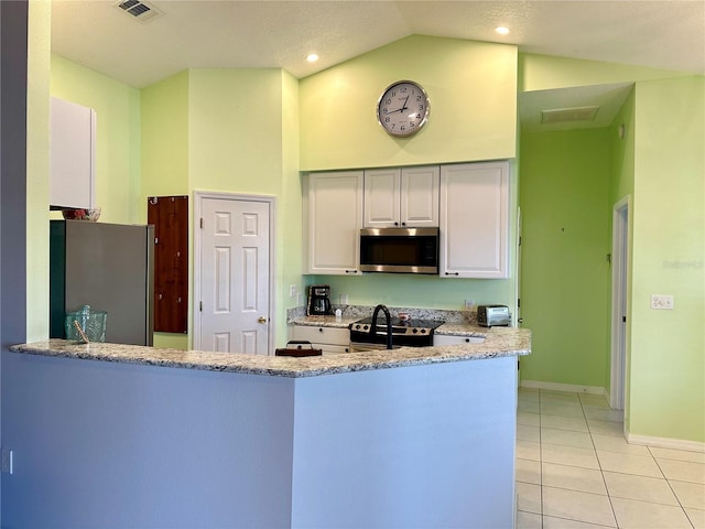 kitchen featuring light stone countertops, stainless steel appliances, white cabinets, kitchen peninsula, and light tile patterned floors