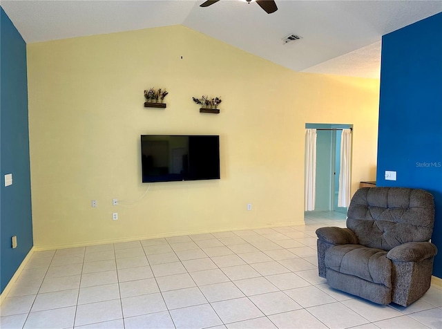 living area with visible vents, a ceiling fan, light tile patterned floors, baseboards, and vaulted ceiling