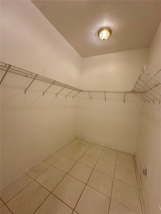 spacious closet featuring light tile patterned floors