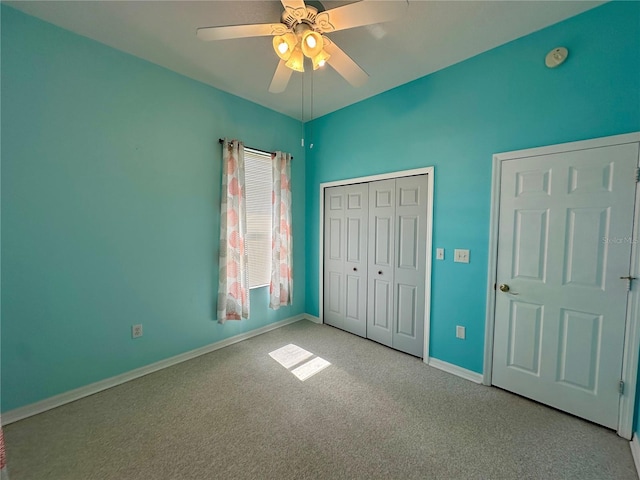 unfurnished bedroom featuring a closet, baseboards, carpet floors, and ceiling fan