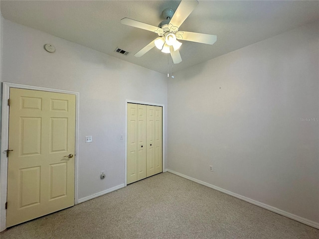 unfurnished bedroom featuring a ceiling fan, baseboards, visible vents, a closet, and carpet flooring