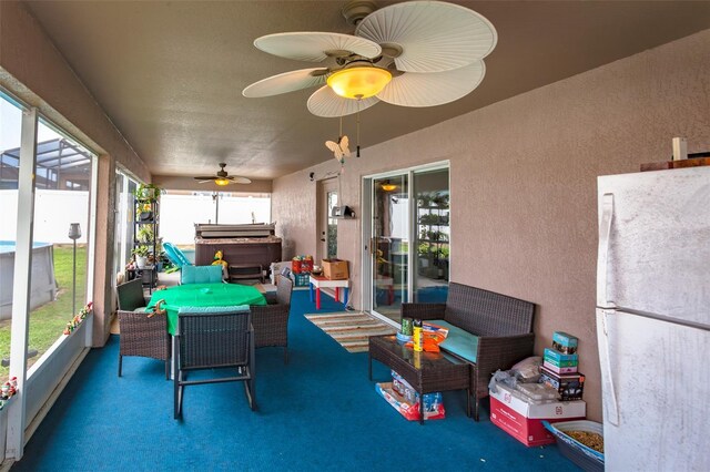 sunroom featuring ceiling fan and a wealth of natural light