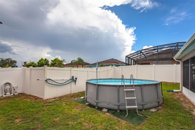 view of yard featuring a lanai and a fenced in pool