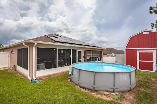 view of swimming pool with a yard and a storage unit