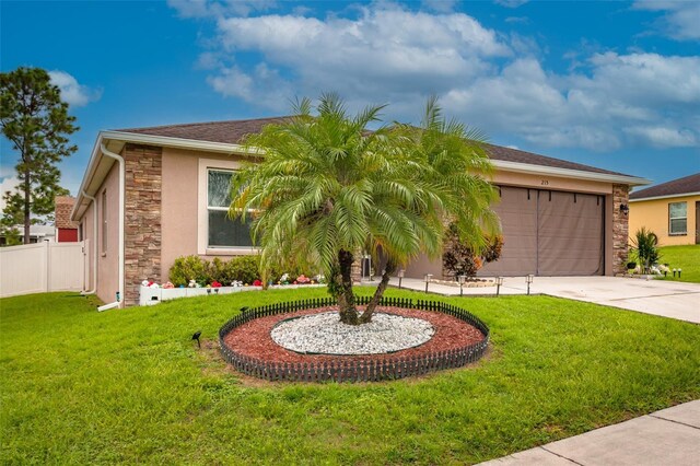 view of front of house featuring a garage and a front lawn