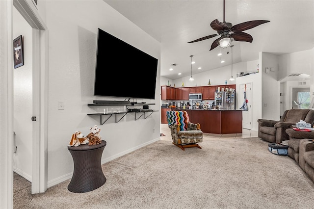 carpeted living room with ceiling fan and vaulted ceiling