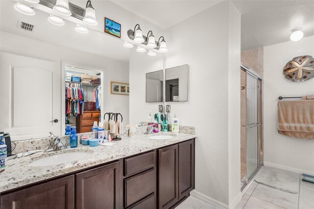 bathroom featuring vanity, tile patterned floors, and an enclosed shower