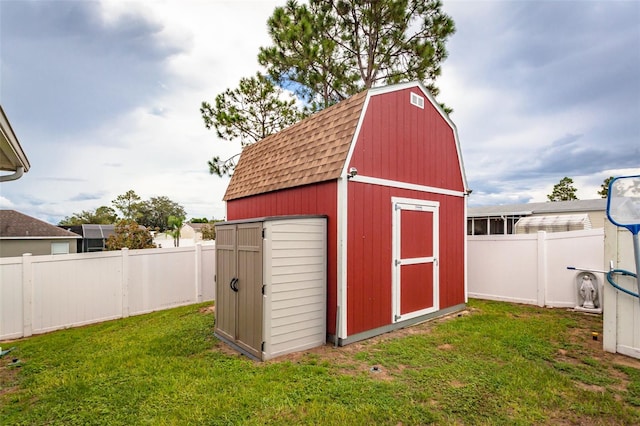 view of outbuilding featuring a lawn