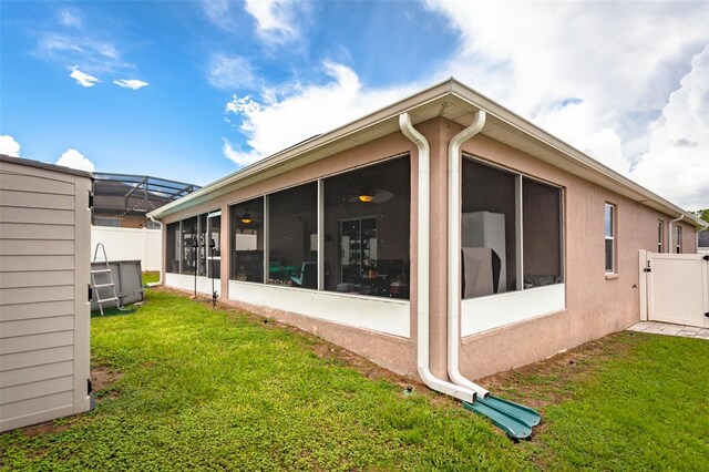 rear view of property featuring a lawn