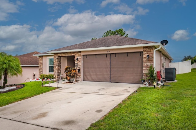 ranch-style home with central air condition unit, a front yard, and a garage