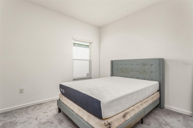 bedroom featuring light colored carpet