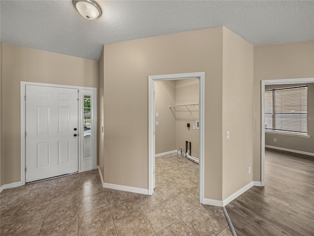 entryway featuring a textured ceiling