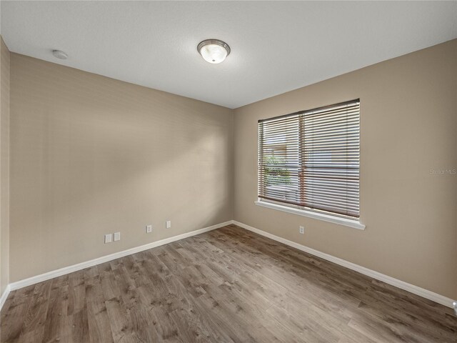 unfurnished room featuring hardwood / wood-style flooring