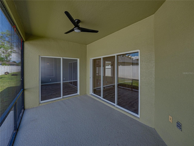 unfurnished sunroom with lofted ceiling and ceiling fan