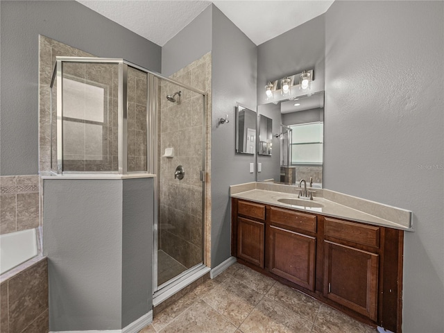 bathroom featuring tile patterned floors, an enclosed shower, and vanity